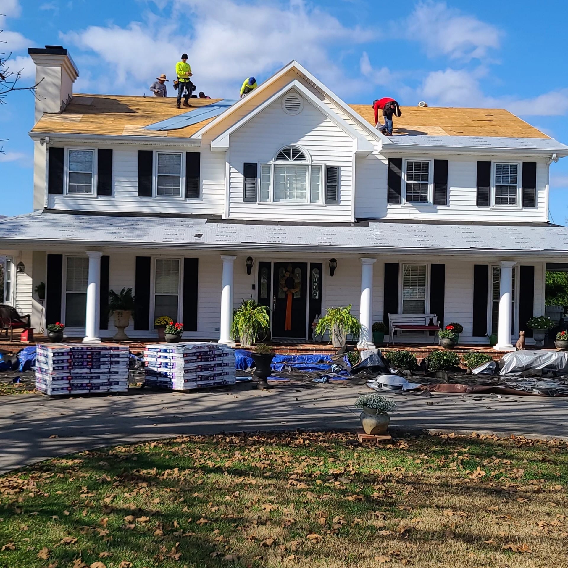Premier Builders' crew working on reroofing a house.