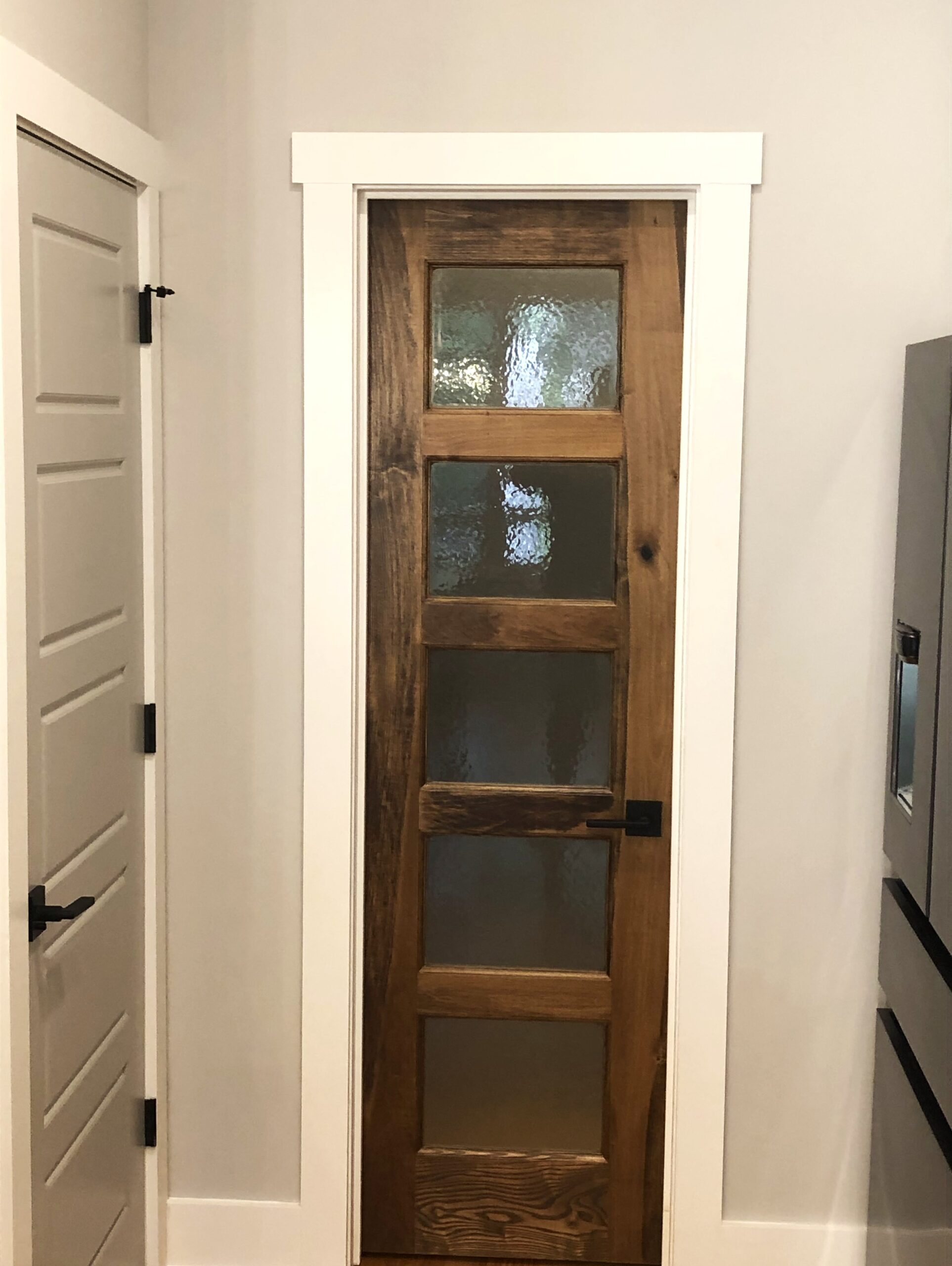 A finished renovation of a pantry door, which creates an opaque and rustic look.